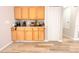 Bright eat-in kitchen features wood-look flooring, wooden cabinets, and stainless appliances at 12652 Chenwood Ave, Hudson, FL 34669