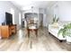 Open-concept living room featuring light tile flooring, ample natural light, and neutral decor at 12652 Chenwood Ave, Hudson, FL 34669