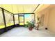 Enclosed patio with concrete flooring, several potted plants, and outdoor view at 12652 Chenwood Ave, Hudson, FL 34669