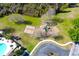 Aerial view of a playground with modern equipment surrounded by green space, offering a safe and enjoyable play area at 12652 Chenwood Ave, Hudson, FL 34669