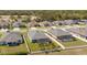 Aerial view of a neighborhood showcasing well-manicured lawns, fenced yards, and sparkling swimming pools at 12749 Weatherstone Dr, Spring Hill, FL 34609