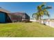 Lush backyard featuring a screened-in patio and a pristine lawn, creating a private and inviting outdoor space at 12749 Weatherstone Dr, Spring Hill, FL 34609