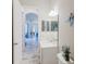 Bright bathroom with sliding glass door and white vanity sink with decorative mirror at 12749 Weatherstone Dr, Spring Hill, FL 34609