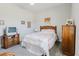 Cozy bedroom features a queen bed, classic furniture and soothing decor at 12749 Weatherstone Dr, Spring Hill, FL 34609