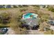 Aerial view of a community pool and recreation area featuring a large pool, clubhouse, and lush landscaping at 12749 Weatherstone Dr, Spring Hill, FL 34609