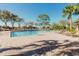 Beautiful community pool with lounge chairs, palm trees, and a spacious sundeck at 12749 Weatherstone Dr, Spring Hill, FL 34609