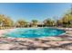 Relaxing community pool with a large pool deck, clear blue water, and lush landscaping at 12749 Weatherstone Dr, Spring Hill, FL 34609