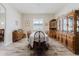 Spacious dining room with wood table, chairs and hutch, illuminated by natural light from a large window at 12749 Weatherstone Dr, Spring Hill, FL 34609