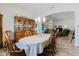 Dining room with china cabinet and wood floors leading to the living room at 12749 Weatherstone Dr, Spring Hill, FL 34609