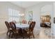 Cozy dining area featuring wood-look tile floors and wicker dining set with beautiful floral table cloth at 12749 Weatherstone Dr, Spring Hill, FL 34609