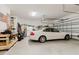 Spacious garage featuring ample storage space, a modern vehicle, and well-lit interiors at 12749 Weatherstone Dr, Spring Hill, FL 34609