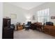 Functional home office featuring a traditional desk, comfortable chair, and ample natural light from the window at 12749 Weatherstone Dr, Spring Hill, FL 34609