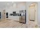 Contemporary kitchen boasting white cabinetry, stainless steel appliances, a mosaic backsplash, and stylish tile flooring at 12749 Weatherstone Dr, Spring Hill, FL 34609
