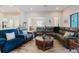 Comfortable living room showcasing stylish furniture, wood-look flooring, and an open-concept design at 12749 Weatherstone Dr, Spring Hill, FL 34609