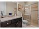 Modern bathroom featuring granite countertops, dark wood cabinets, and a glass-enclosed shower at 12835 Sorrento Way, Bradenton, FL 34211