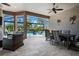 Outdoor patio featuring dining table, seating, fireplace and lush landscape with pool views at 12835 Sorrento Way, Bradenton, FL 34211