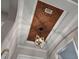 Close-up of the decorative tray ceiling with an eye-catching geometric light fixture in the entryway at 13218 Sorrento Way, Bradenton, FL 34211