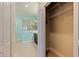 Bathroom area featuring a spacious walk-in shower with glass doors and wire shelving storage in walk in closet at 13574 Circa Crossing Dr, Lithia, FL 33547