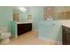 Bathroom showcasing dual vanities, ample counter space, and a glass-enclosed shower, blending functionality with style at 13574 Circa Crossing Dr, Lithia, FL 33547