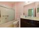 Bathroom featuring a shower-tub combo with sliding glass doors, vanity and updated fixtures at 13574 Circa Crossing Dr, Lithia, FL 33547