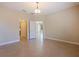 Bright bedroom with neutral walls, tile flooring, and open doorways to other rooms at 13574 Circa Crossing Dr, Lithia, FL 33547