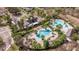 Aerial view of the community pool and clubhouse surrounded by lush landscaping at 13574 Circa Crossing Dr, Lithia, FL 33547
