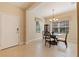 Cozy dining area featuring a round glass table and elegant chandelier lighting at 13574 Circa Crossing Dr, Lithia, FL 33547