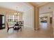 Elegant dining room featuring a glass-top table, decorative chandelier, and ample natural light, ideal for gatherings at 13574 Circa Crossing Dr, Lithia, FL 33547