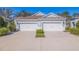 A double garage home with a large driveway and lush green landscaping at 13574 Circa Crossing Dr, Lithia, FL 33547