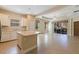 Open-concept kitchen with white cabinets, a center island, and seamless access to the living area at 13574 Circa Crossing Dr, Lithia, FL 33547
