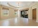 Sun-filled living room with screened doors leading to the outdoor patio at 13574 Circa Crossing Dr, Lithia, FL 33547