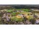 Aerial view of the community's well-maintained baseball and football fields surrounded by lush trees at 13574 Circa Crossing Dr, Lithia, FL 33547