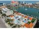 Aerial view showcases the condo's rooftop amenities with colorful buildings and waterfront views at 140 Brightwater Dr # 1, Clearwater Beach, FL 33767