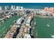 An elevated view showcasing waterfront townhomes with boat docks, near the beach and featuring rooftop terraces at 140 Brightwater Dr # 1, Clearwater Beach, FL 33767