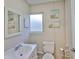 A stylish half bathroom with coastal themed decor, vanity and mirror at 140 Brightwater Dr # 1, Clearwater Beach, FL 33767