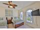 Bright bedroom featuring tropical decor, ceiling fan, and natural light at 140 Brightwater Dr # 1, Clearwater Beach, FL 33767