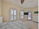 Bright bedroom with ample natural light, balcony access and neutral carpet at 140 Brightwater Dr # 1, Clearwater Beach, FL 33767