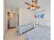 Comfortable bedroom featuring two twin beds, beachy decor, and ample natural light at 140 Brightwater Dr # 1, Clearwater Beach, FL 33767