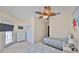Comfortable bedroom with two twin beds, ceiling fan and balcony access at 140 Brightwater Dr # 1, Clearwater Beach, FL 33767