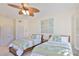 Bright guest bedroom with two beds, ceiling fan, and tropical themed decor at 140 Brightwater Dr # 1, Clearwater Beach, FL 33767