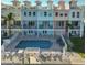 Aerial view of multi-story condos with a refreshing in-ground swimming pool at 140 Brightwater Dr # 1, Clearwater Beach, FL 33767
