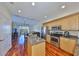 Open kitchen with stainless steel appliances, granite countertops, and hardwood floors at 140 Brightwater Dr # 1, Clearwater Beach, FL 33767