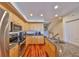Well-lit kitchen with stainless steel appliances, granite counters, and hardwood flooring at 140 Brightwater Dr # 1, Clearwater Beach, FL 33767