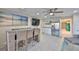 A large open-plan living room with bar seating, stainless appliances, and coastal decor at 140 Brightwater Dr # 1, Clearwater Beach, FL 33767