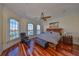 Bright primary bedroom featuring water views, wooden floors, and a ceiling fan at 140 Brightwater Dr # 1, Clearwater Beach, FL 33767