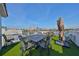 Entertain on this rooftop deck with synthetic grass, outdoor table, and views of the city at 140 Brightwater Dr # 1, Clearwater Beach, FL 33767