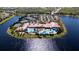 Panoramic aerial view showcasing tennis courts, a parking area, lakes and a stunning community center at 15908 Cobble Mill Dr, Wimauma, FL 33598
