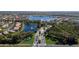 Wide aerial view showcases houses by the lake with multiple fountains and lush landscaping at 15908 Cobble Mill Dr, Wimauma, FL 33598