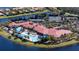 Aerial view of the community featuring tennis courts, multiple pools and a luxurious community center surrounded by nature at 15908 Cobble Mill Dr, Wimauma, FL 33598