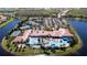 Aerial view of the community featuring tennis courts, a community center, parking and multiple pools and lakes at 15908 Cobble Mill Dr, Wimauma, FL 33598